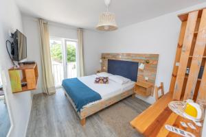 a bedroom with a bed and a table and a television at Boho House in Pakoštane