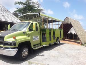 a green truck parked in front of a building at Sea World Vacation Home in Roseau