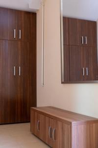 a room with two wooden cabinets and a table at Nema s Apartment 1 in Braşov