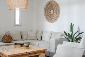 Sala de estar con sofá blanco y mesa de centro en Elea Suites & Residences, en Gouves
