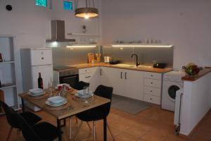 a kitchen with a table and chairs and a kitchen with a sink at Sea and Mountain View in Kalamata