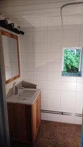 a bathroom with a sink and a window at Näkna Hill in Åby