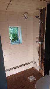 a bathroom with a shower and a window at Näkna Hill in Åby