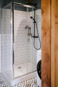 a shower with a glass door in a bathroom at Piękne Pole in Łaziska