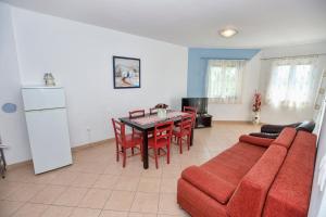 a living room with a red couch and a table at Ferienhaus Elena, Karlobag in Karlobag