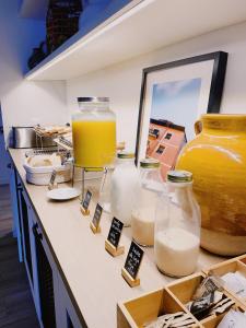 a counter with three jars of milk and a vase at LATROUPE La Granja in Bilbao