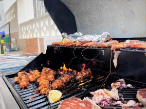 a grill with shrimp and other food on it at Vista Bahia II Apartment in Albir