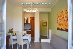a living room with a table and a dining room at Red & Blu Apartments in Desenzano del Garda