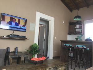 a living room with a flat screen tv on the wall at Cabañas Los 4 elementos - Uspallata in Las Heras