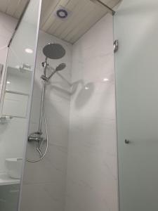 a shower with a glass door in a bathroom at Dream Apartment Tsaghkadzor in Tsaghkadzor