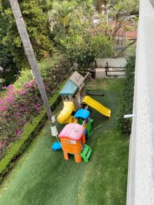 a childs play set on the grass in a backyard at Casa Francisco in Cuernavaca