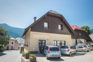 a house with cars parked in front of it at Apartment Amak with free onsite parking in Bovec