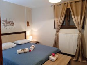 a bedroom with two beds with towels on them at FANTASY GRAND VILLA THASSOS in Astris