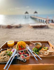 a tray of food on a table on a beach at Nerea Tulum in Tulum