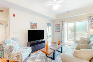 a living room with a tv and a couch and chairs at Eagles Landing - 4300 Sandpiper #4314 in Rehoboth Beach