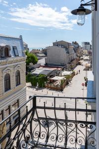 a balcony with a view of a city with buildings at Olympic Boutique in Constanţa