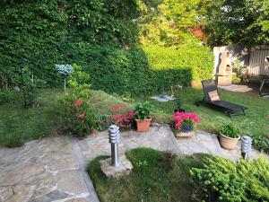 a garden with potted plants and a bench at Domek góralski Spełnione Marzenia in Falsztyn