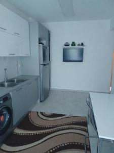 a kitchen with a refrigerator and a washer in it at Seaside Christina Apartments in Ierissos