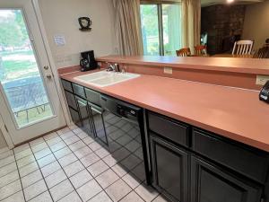 a kitchen with a sink and a counter at Trailside Vacation Home 7 in Bella Vista