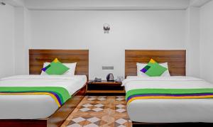 two beds in a room with rainbow pillows at The Royale Crest in Gangtok