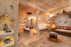 a large room with two beds in a stone building at Kayata Cave Suites Special Class in Urgup