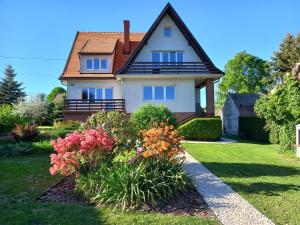 a house with a bunch of flowers in the yard at Złota#208 in Złota