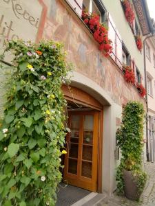 un edificio con una puerta con flores. en B&B Ferienwohnung in bester Lage, en Wangen im Allgäu
