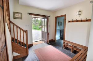 a hallway with a staircase and a door to a room at The Press House in Carrbridge