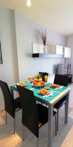 a dining room table with food and drinks on it at Chilly Apartment - Sunny rooftop terrace with ocean view in Callao Salvaje