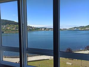 a view of a lake from a window at Ría de Viveiro 2 in Viveiro
