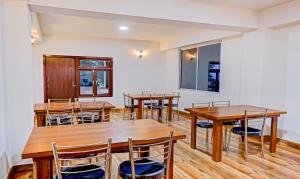 a dining room with wooden tables and chairs at The Royale Crest in Gangtok