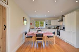 a kitchen with a table and chairs in a room at 7B Ardroil in Uig