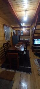 a dining room with a table and chairs in a room at Crkvine Chalet in Kolašin