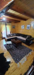 a living room with a couch and a table at Crkvine Chalet in Kolašin