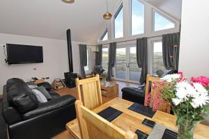 a living room with a table and a couch at Ceann an Loch Cottage in Balallan