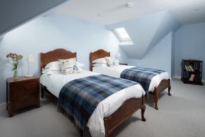 Beltie Lodge tesisinde bir odada yatak veya yataklar