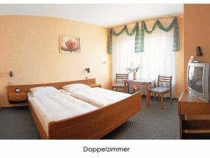 Giường trong phòng chung tại Hotel Keinath Stuttgart