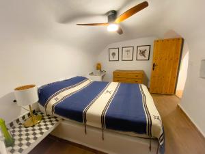 a bedroom with a bed and a ceiling fan at Cueva Ventica in Benamaurel +68 photos