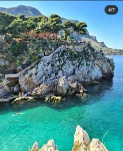 a view of a rocky island in the water at B&B Donna Sabella in Santa Flavia