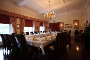 a large dining room with a long table and chairs at Fernhill Hotel in Lyme Regis +37 photos