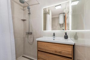 a bathroom with a white sink and a shower at Apartment Bellistra Rabac in Rabac +19 photos