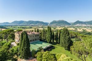 an aerial view of a building with trees and mountains at Antica Villa Castelli in Gubbio