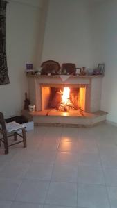 a fireplace in the middle of a living room at Eva's apartments in Nafpaktos