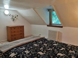 a bedroom with a bed and a dresser and a window at Arrochar Fern Cottage with Wood Burner & Loch View in Arrochar