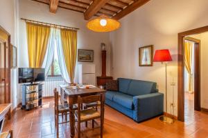 a living room with a couch and a table at Antica Villa Castelli in Gubbio