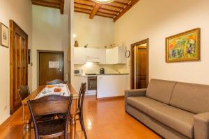a living room with a couch and a table with chairs at Antica Villa Castelli in Gubbio