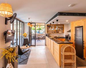 a kitchen with a counter and a dining room at Yerli Alaçatı in Alaçatı