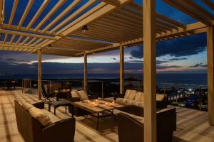 a patio with a table and chairs on a deck at Happy Days Villa A in Fajardo