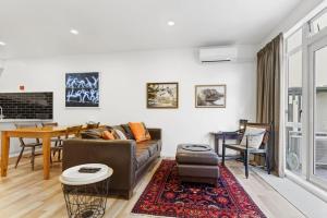 a living room with a couch and a table at CBD Spacious 3 Storey Terrace House with Courtyard in Auckland