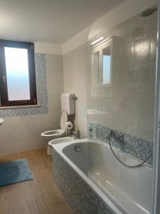 a bathroom with a tub and a toilet at Casa Drema - Villa al mare con terrazza in Pescara +92 photos